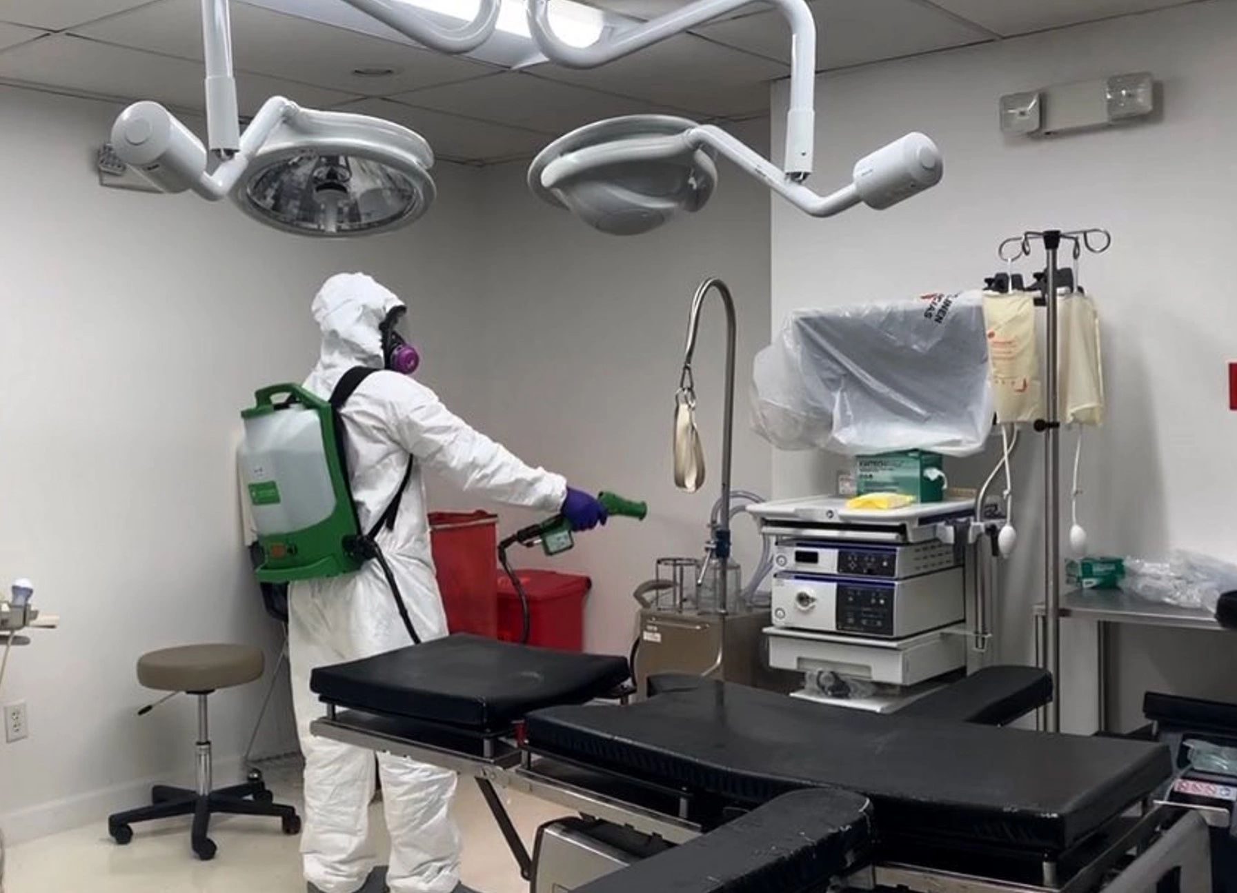 Technician applying MicrobeCare antimicrobial treatment in a medical facility